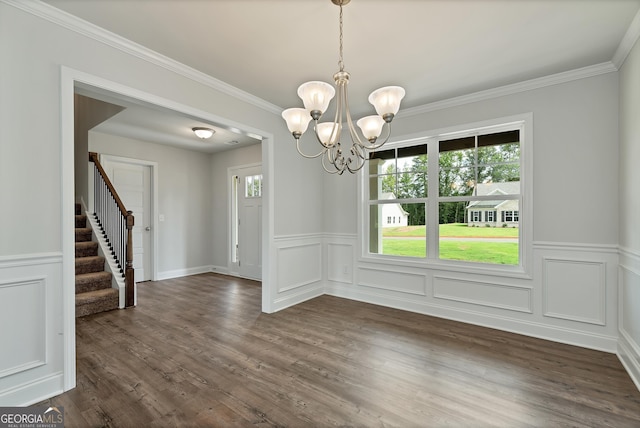 unfurnished dining area with ornamental molding, stairway, dark wood finished floors, and a notable chandelier