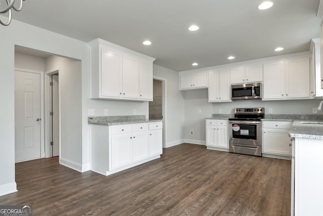 kitchen featuring appliances with stainless steel finishes, recessed lighting, white cabinets, and dark wood-type flooring