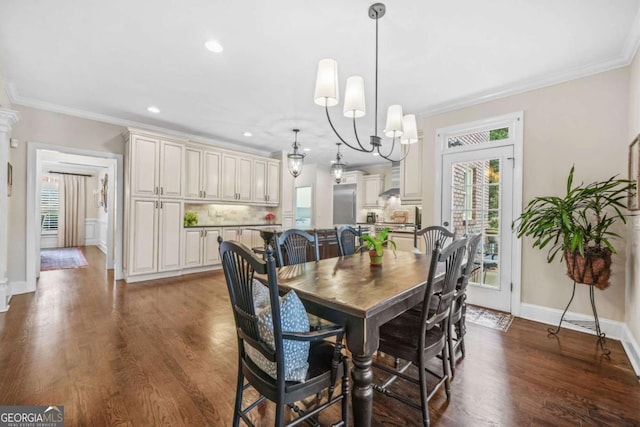 dining space featuring dark wood finished floors, a notable chandelier, crown molding, and recessed lighting