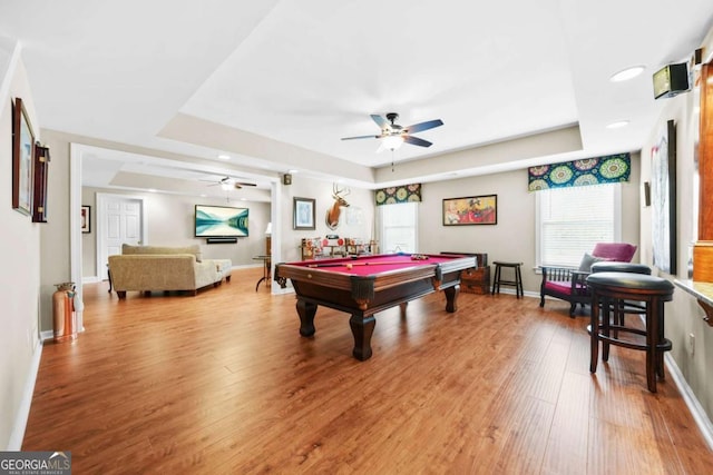 game room featuring light wood finished floors, billiards, a tray ceiling, and baseboards