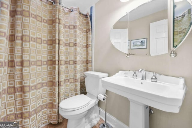 bathroom featuring toilet and a sink