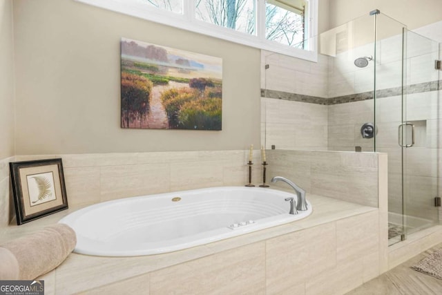 bathroom with a garden tub and a shower stall