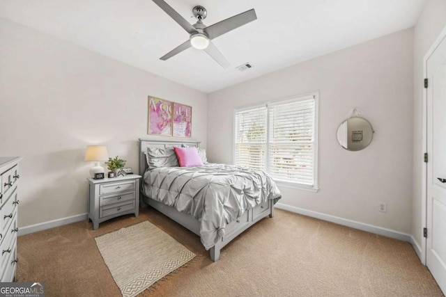 bedroom featuring baseboards, visible vents, a ceiling fan, and light colored carpet