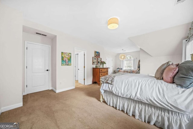 carpeted bedroom with visible vents and baseboards