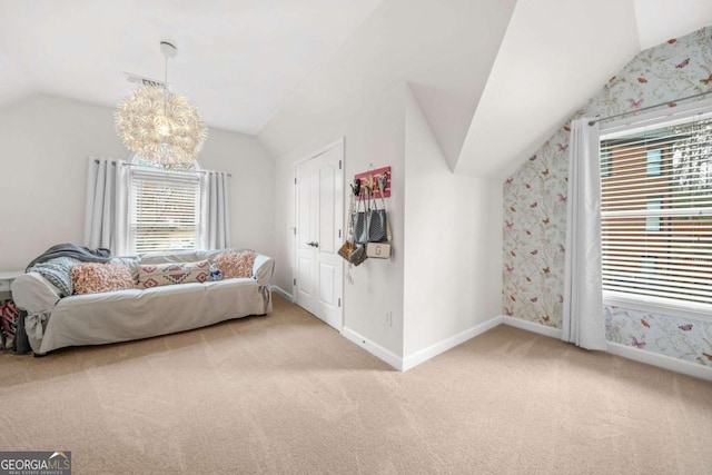 carpeted bedroom featuring vaulted ceiling, a chandelier, visible vents, and baseboards