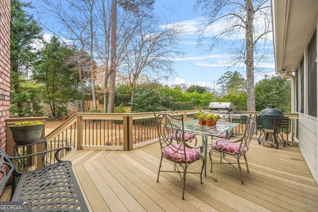 wooden deck featuring outdoor dining space and area for grilling