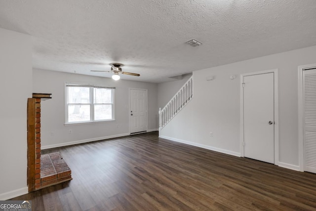 unfurnished living room featuring dark wood-style floors, stairway, visible vents, and baseboards