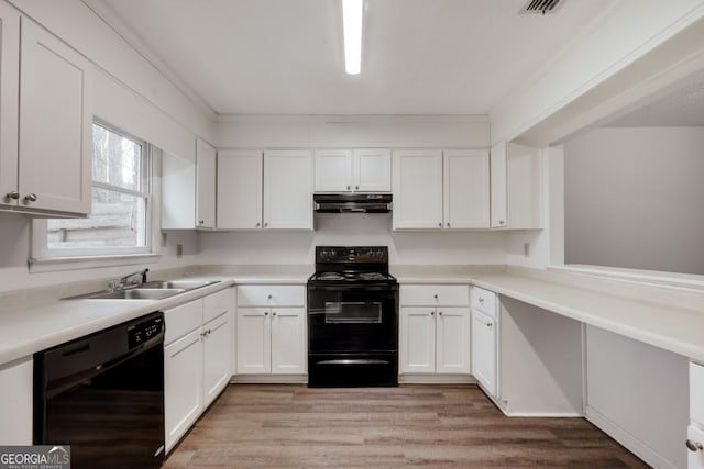 kitchen featuring black appliances, under cabinet range hood, white cabinetry, and a sink