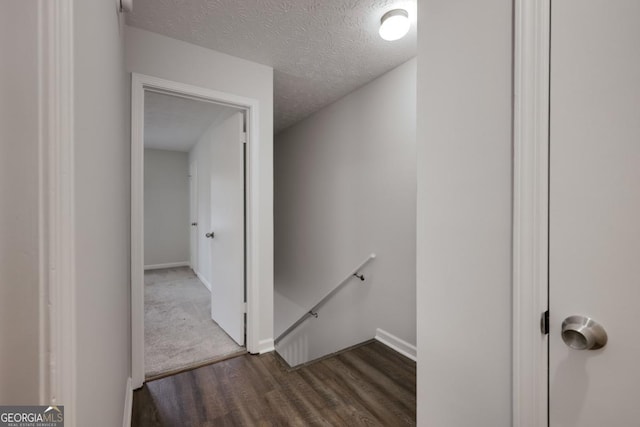 interior space featuring a textured ceiling and wood finished floors