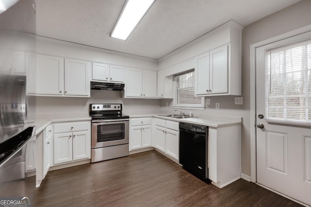 kitchen featuring dark wood finished floors, dishwasher, under cabinet range hood, stainless steel range with electric stovetop, and white cabinetry