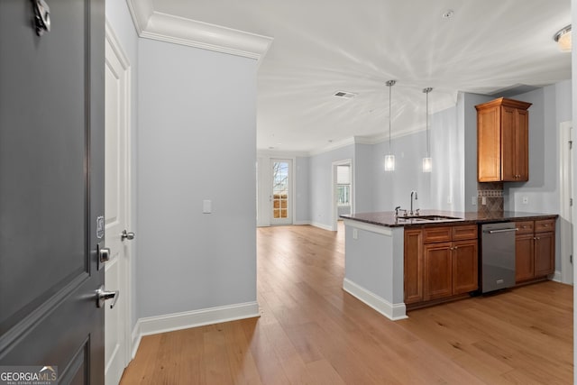 kitchen featuring visible vents, brown cabinetry, a sink, light wood-type flooring, and dishwasher