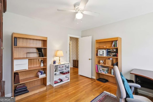 home office with light wood-style floors and a ceiling fan