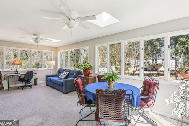 sunroom / solarium featuring a skylight and ceiling fan