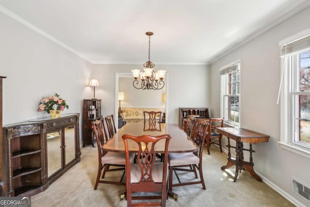 dining space featuring light carpet, a chandelier, visible vents, and crown molding