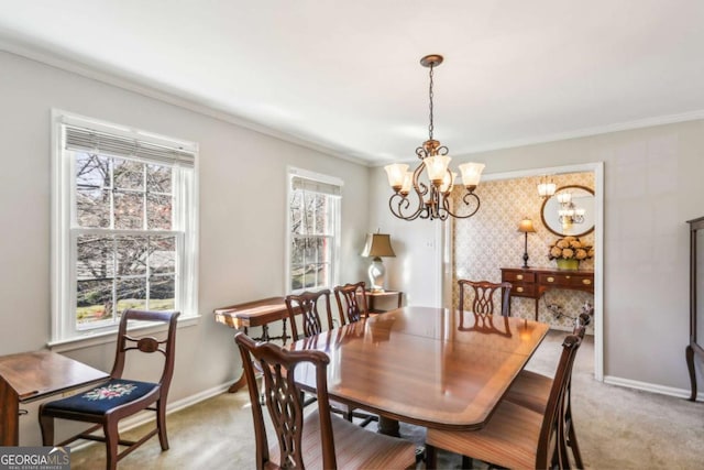 dining area featuring baseboards, ornamental molding, a notable chandelier, and light colored carpet