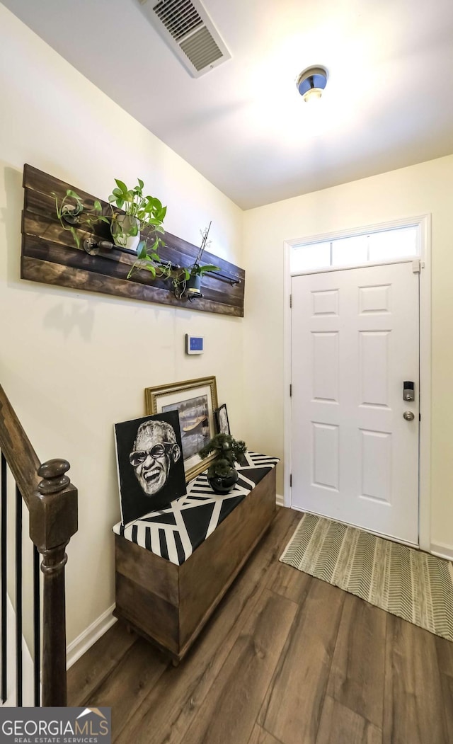 entryway featuring stairway, wood finished floors, visible vents, and baseboards