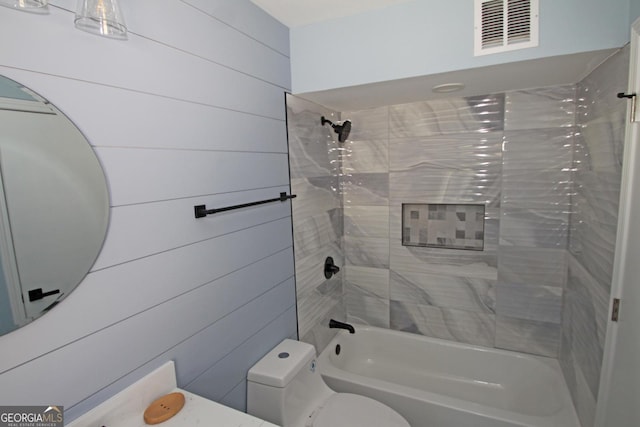 full bathroom with bathing tub / shower combination, toilet, and visible vents