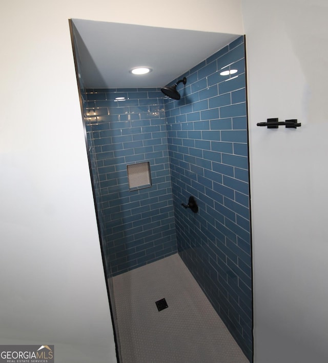 bathroom with tiled shower