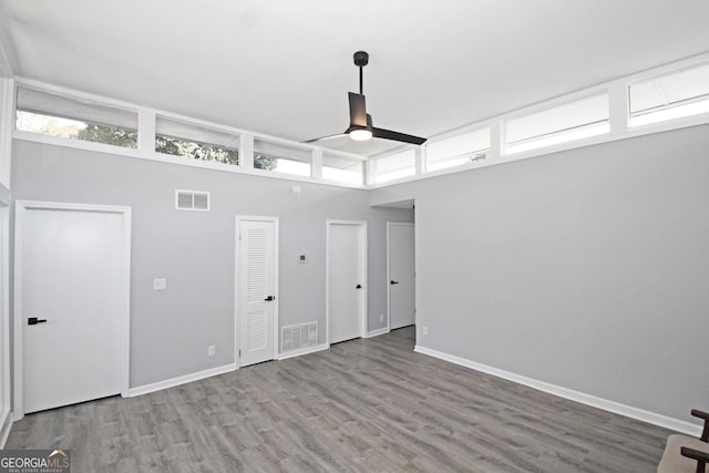 interior space featuring wood finished floors, visible vents, and baseboards