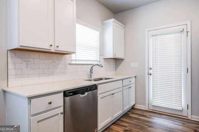 kitchen with dark wood-style floors, tasteful backsplash, white cabinetry, a sink, and dishwasher