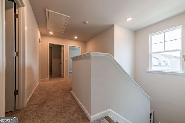 corridor featuring recessed lighting, an upstairs landing, baseboards, carpet, and attic access