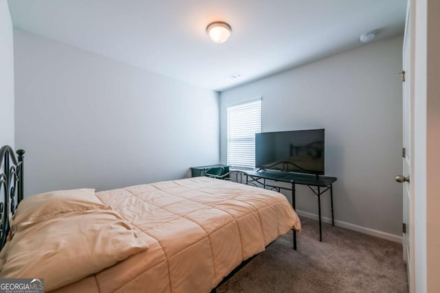 bedroom with carpet floors and baseboards