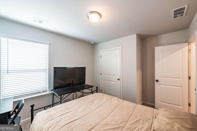 bedroom with visible vents and baseboards