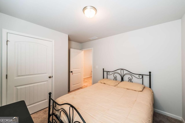 carpeted bedroom featuring visible vents and baseboards