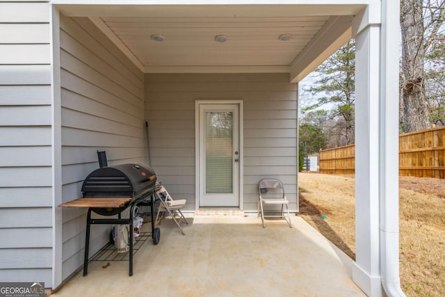 doorway to property with a patio and fence