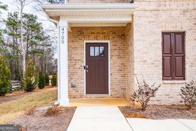 property entrance with brick siding