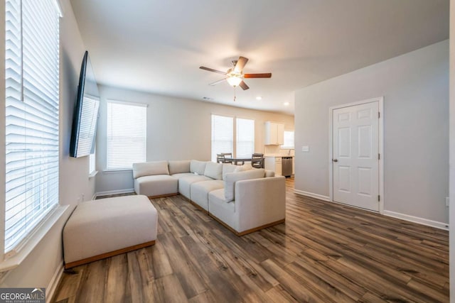 living area with dark wood-style floors, recessed lighting, a ceiling fan, and baseboards