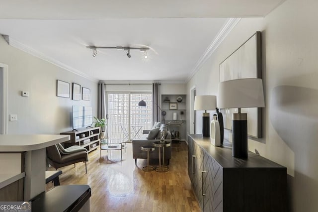 living area with crown molding and wood finished floors