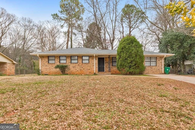 single story home featuring brick siding, fence, and a front lawn