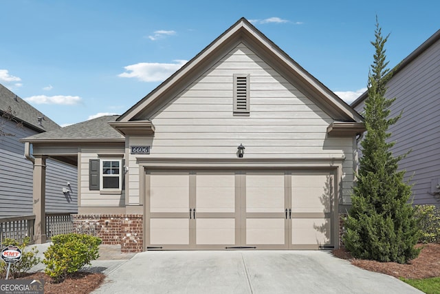 exterior space with brick siding, driveway, and an attached garage