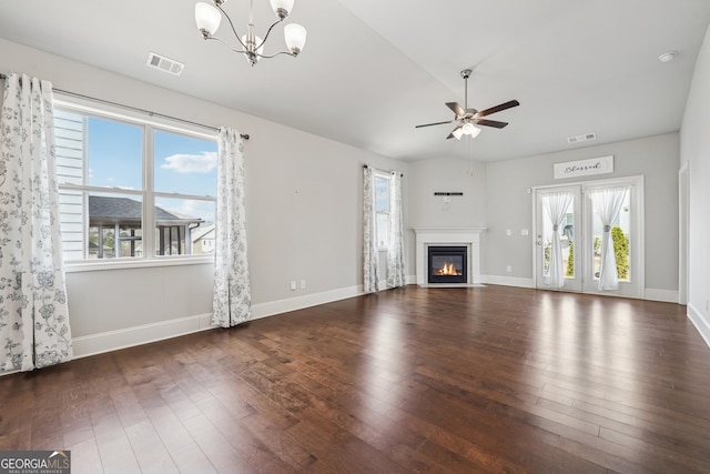 unfurnished living room with visible vents, ceiling fan with notable chandelier, hardwood / wood-style flooring, a glass covered fireplace, and baseboards