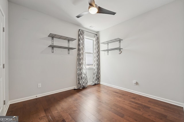 empty room with visible vents, baseboards, ceiling fan, and wood finished floors