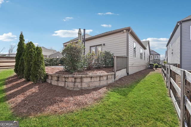 exterior space with a yard and fence