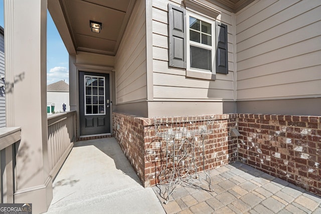 property entrance with brick siding