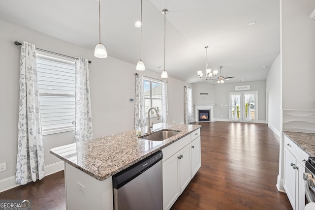 kitchen featuring a glass covered fireplace, dark wood-style flooring, appliances with stainless steel finishes, and a sink