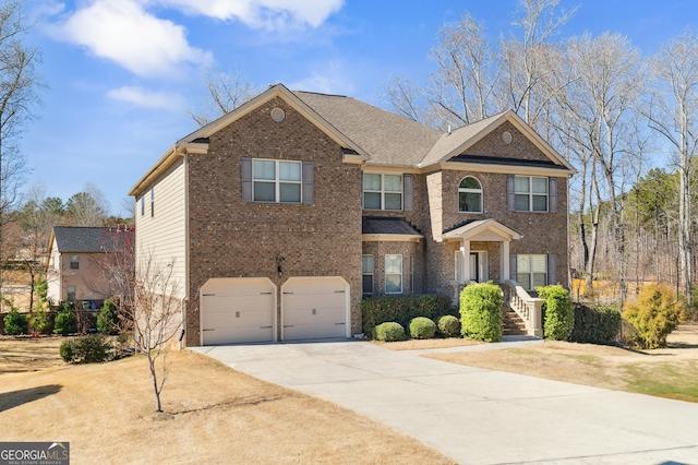 view of front of property featuring a garage, brick siding, and driveway