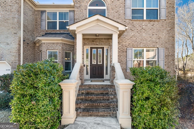 view of exterior entry with brick siding