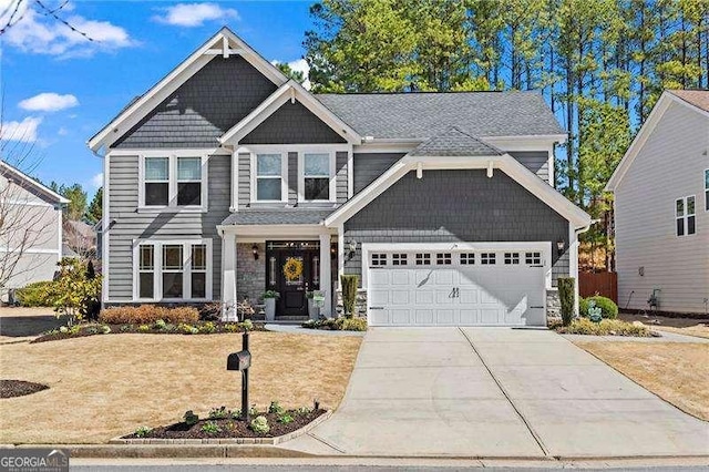 craftsman-style home featuring a garage, concrete driveway, and a front lawn