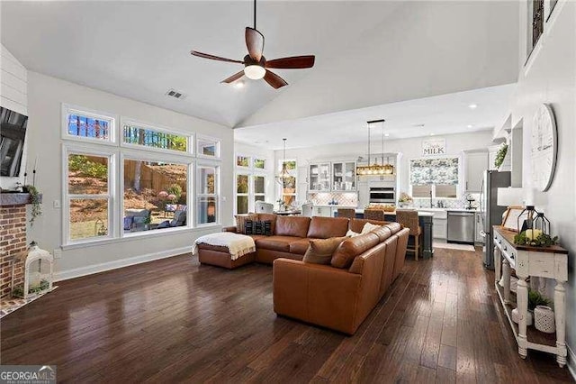 living room with dark wood finished floors, a fireplace, visible vents, a ceiling fan, and high vaulted ceiling