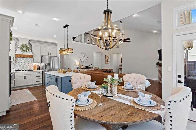 dining area with a chandelier, recessed lighting, and dark wood-type flooring