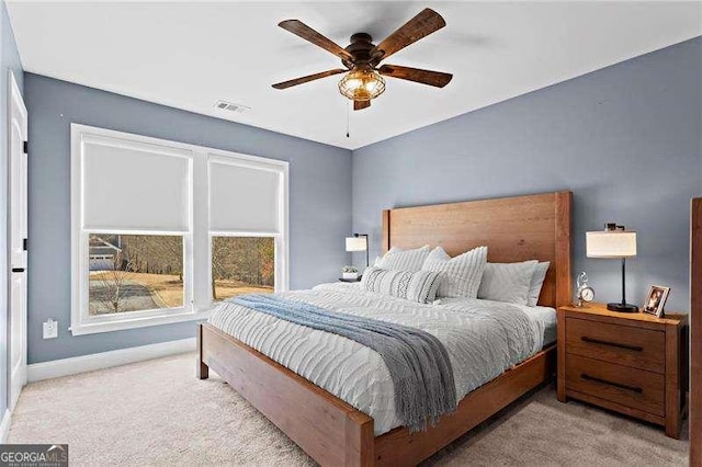 bedroom featuring a ceiling fan, carpet, visible vents, and baseboards