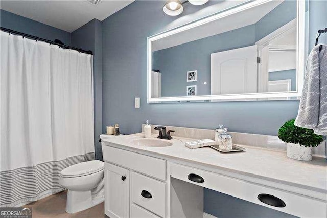 bathroom with toilet and vanity