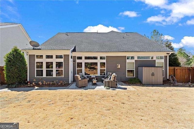 rear view of house with an outdoor hangout area, a patio, a yard, and fence