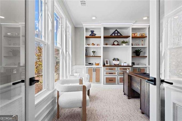 interior space featuring ornamental molding, built in shelves, visible vents, and recessed lighting