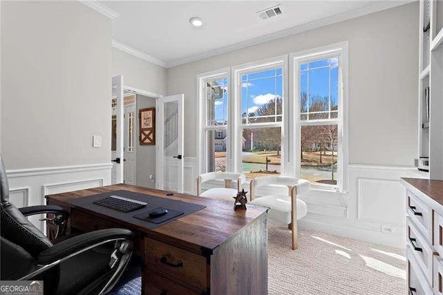 office with visible vents, a wainscoted wall, ornamental molding, carpet flooring, and a decorative wall