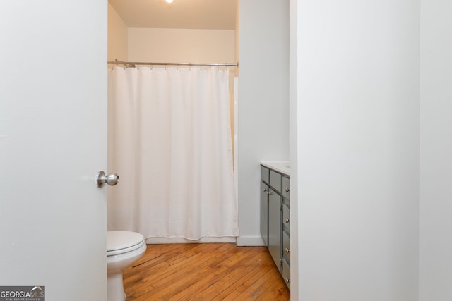 bathroom with vanity, toilet, a shower with curtain, and wood-type flooring